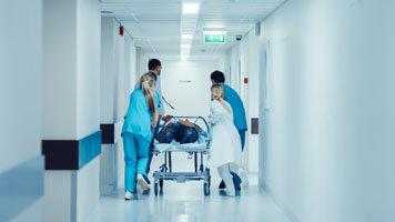 Doctors and Nurses Rushing Patient to Operating Room